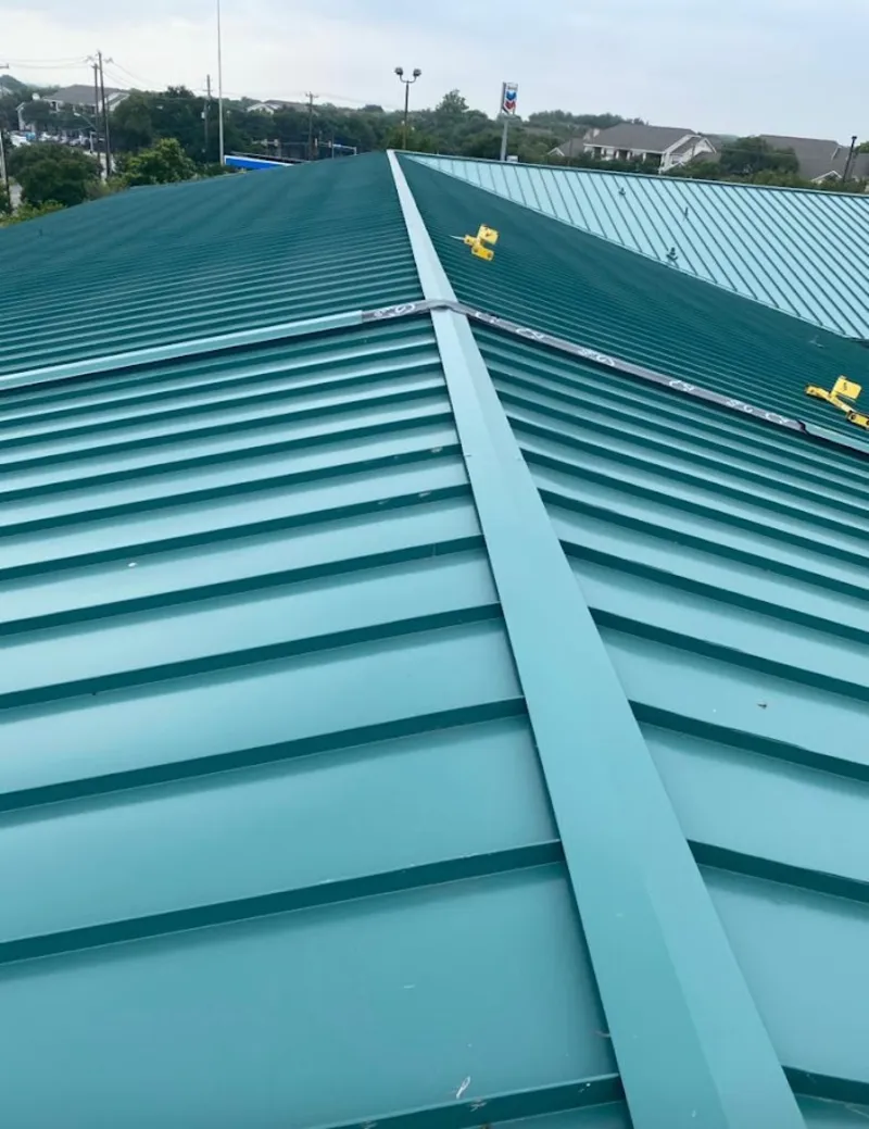 Green commercial metal roof ridge and valley for Metal Roof Repair in Petoskey