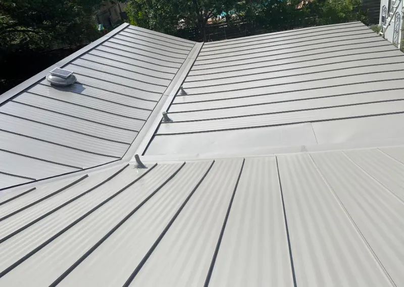 Solar attic fan installed on a metal roof for Roof Ventilation in Petoskey
